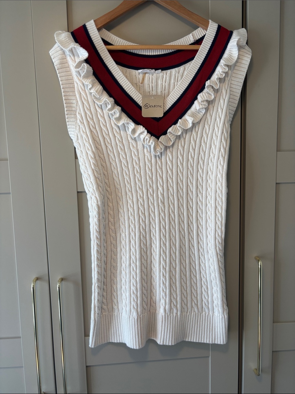 The Upside White Cable-Knit Sleeveless V-Neck Sweater with Red & Navy Trim